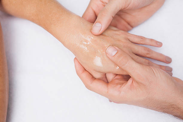 istock Manicurist washing customers hand 519562571