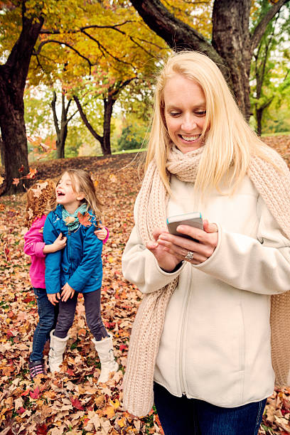 istock Mom on the phone missing out precious time with kids. 519570659