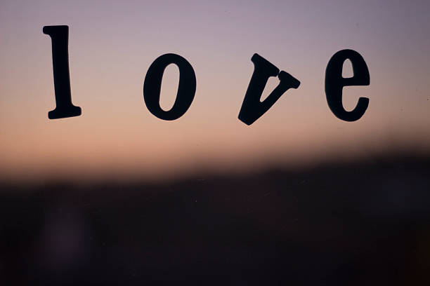 istock Word love spelled in letters on window with sunset 519571761