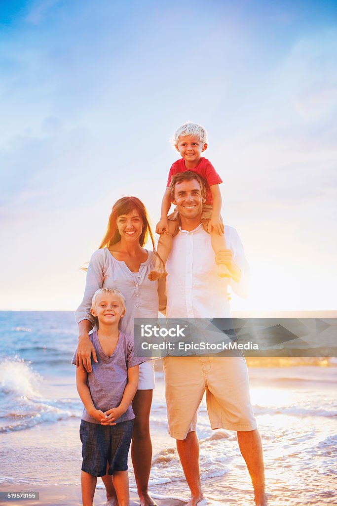 Portrait of Family on the Beach at Sunset Happy Young Family on the Beach at Sunset Activity Stock Photo