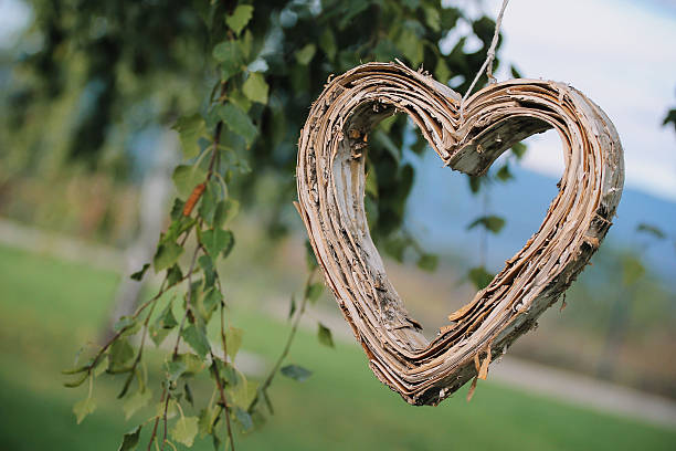 Wooden heart hanging from the tree.