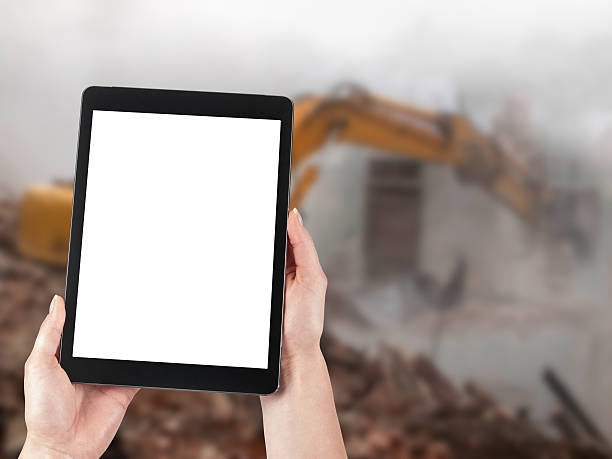 istock Tablet and excavator in the background 519575617