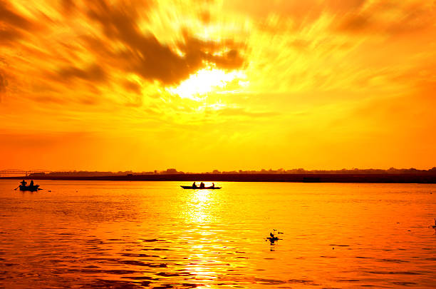 istock boat sailors at sunrise sunset 519575795