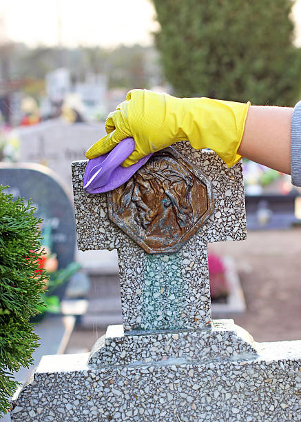 cleaning of the monument at cemetery stock photo