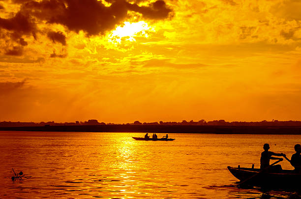 istock boat sailors at sunrise sunset 519577751