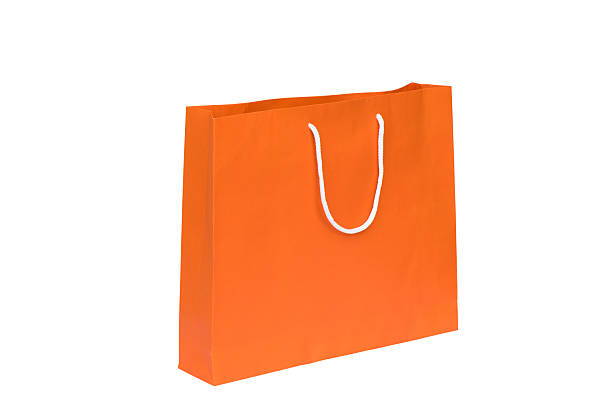 istock Orange shopping bag isolated 519577861