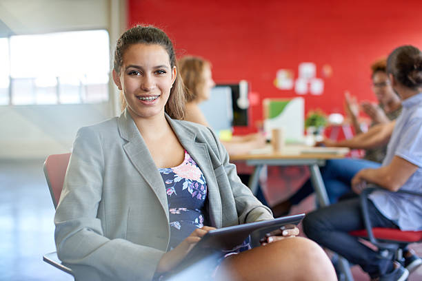 istock Confident female designer working on a digital tablet in red 519578258