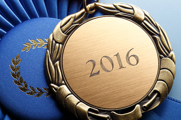 istock Gold Medal Engraved With 2016 Resting On Blue Ribbon 519579242