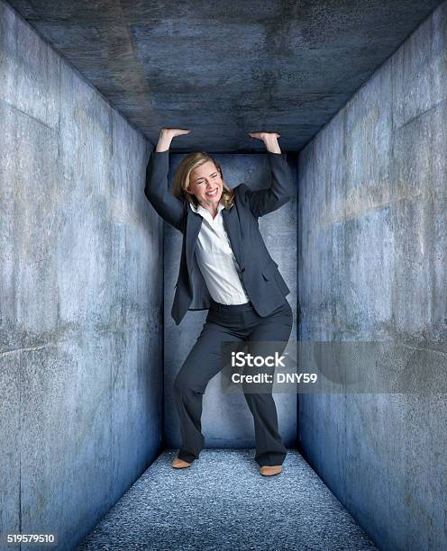 Businesswoman Trapped In Small Space Stock Photo - Download Image Now - 30-34 Years, Adult, Adversity