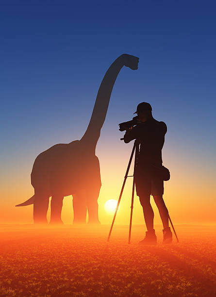 istock Photographer and dinosaur 519584290