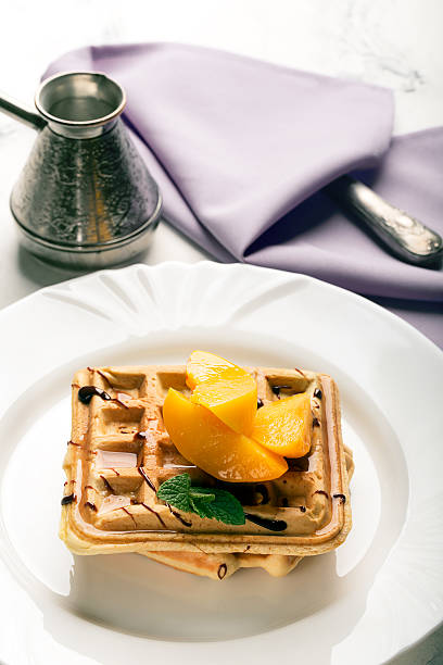 istock Viennese waffles with peaches and chocolate 519585154