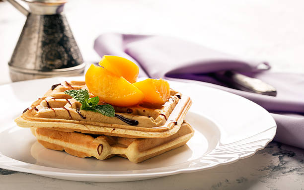 Viennese waffles with peaches and chocolate stock photo