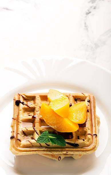 istock Viennese waffles with peaches and chocolate 519585190