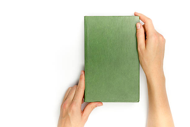 Hands hold blank red hardcover book on white background.