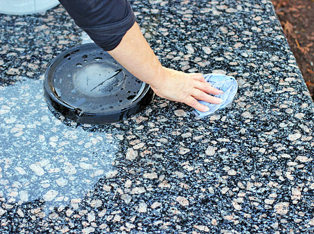 cleaning of the monument at cemetery stock photo