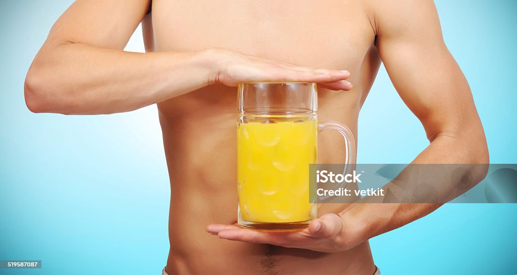 glass of juice muscular man holding a glass of juice Drinking Stock Photo