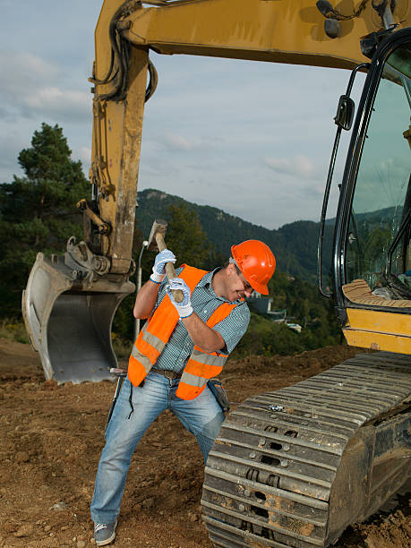 istock repairman fixing excavator track 519587563
