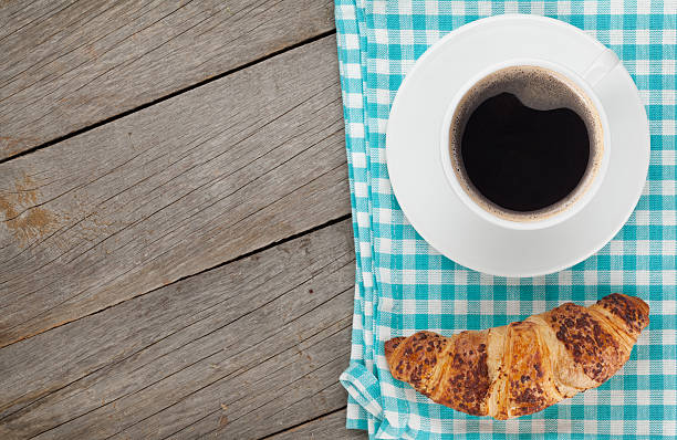 istock Cup of coffee and fresh croissant 519588713