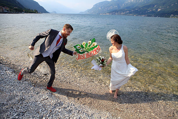 istock Bride and groom having fun on the beach 519590007