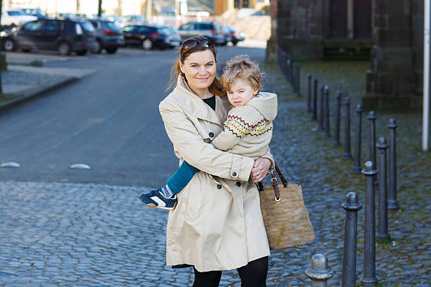 istock Happy little boy sitting on mum's arms 519590409