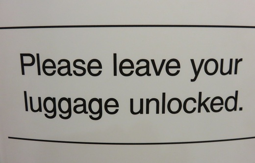 Sign at the airport - for the security check, leave your bags unlocked