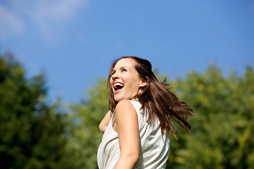 Close up portrait of an attractive woman laughing outdoors