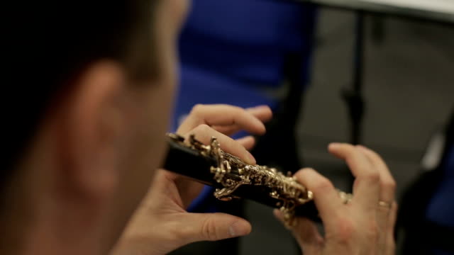 Human Hands Playing The Oboe
