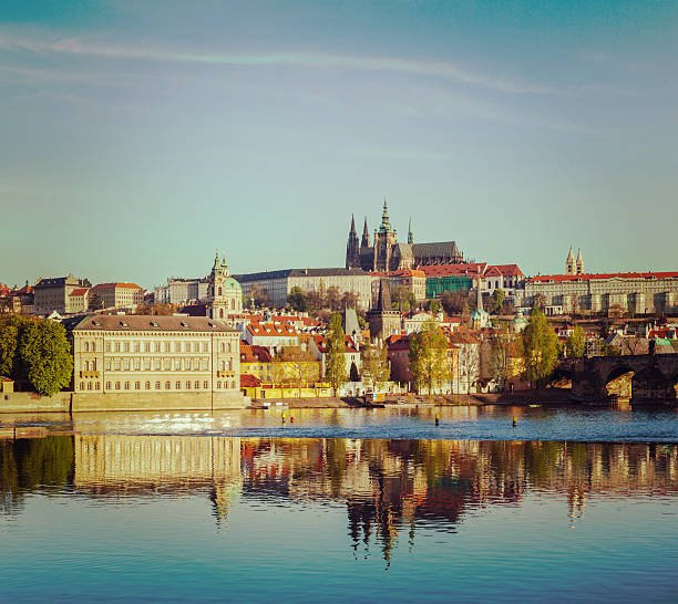 Vintage retro hipster style travel image of Mala Strana and  Prague castle over Vltava river. Prague, Czech Republic