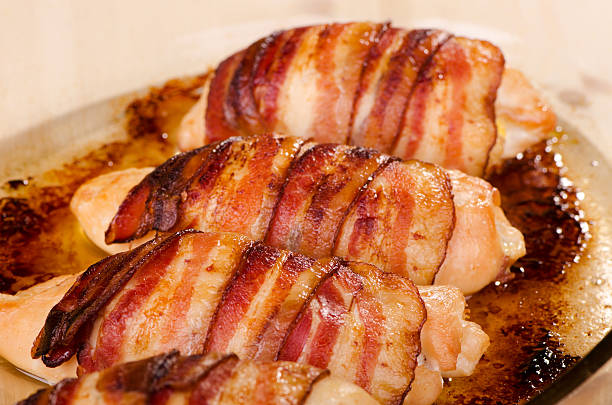 Baked chicken fillet wrapped in bacon, stuffed with cheese