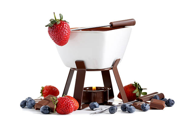 Chocolate fondue with fresh berries isolated on a white stock photo