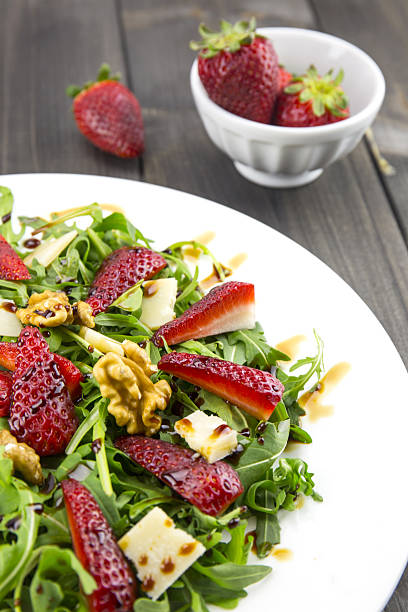 istock Spring salad with strawberries, rocket salad, parmesan cheese. 519613530