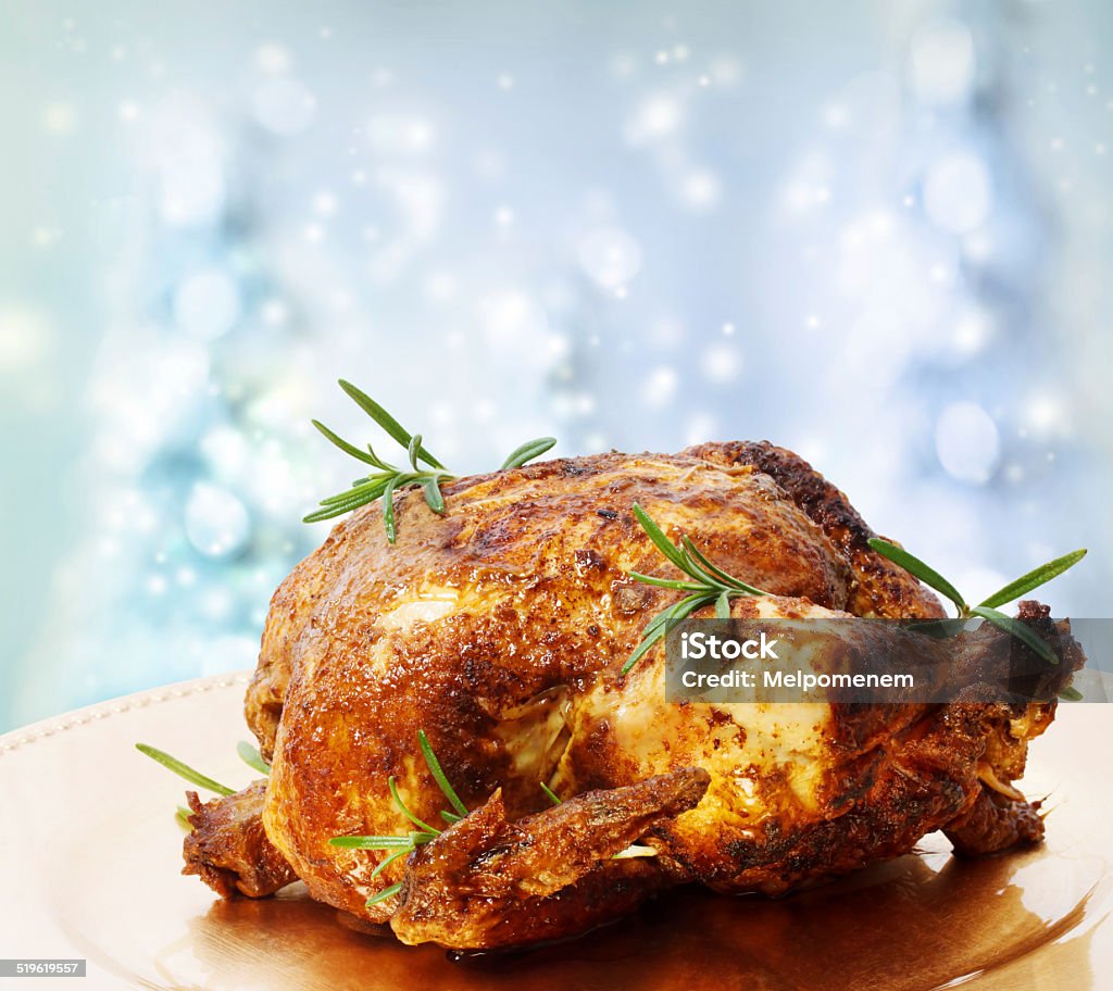 Roasted Whole Chicken with Rosemary Roasted Whole Chicken with Rosemary on a Winter Blue Backdrops Backgrounds Stock Photo