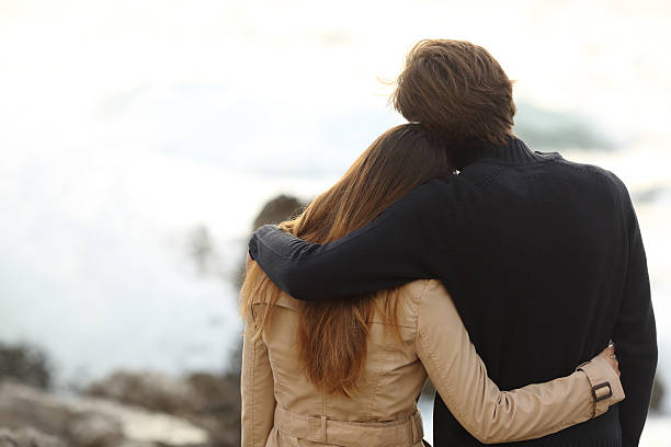 istock Back view of a couple cuddling in winter 519620229