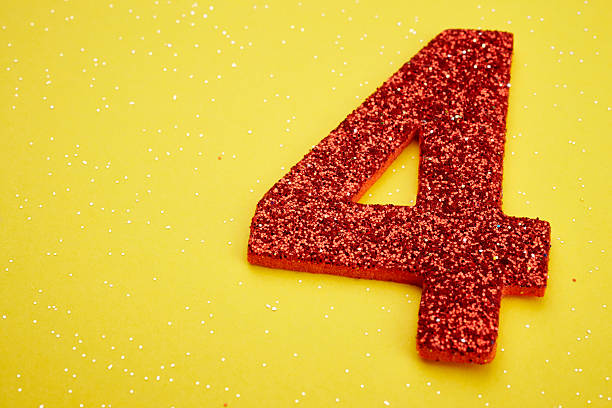 istock Number four red color over a yellow background. Anniversary 519621386