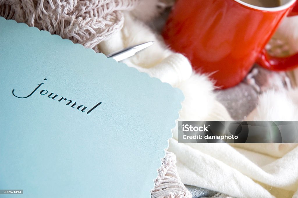 blue journal book blue journal book put on desk with scarf and cup of coffee Activity Stock Photo
