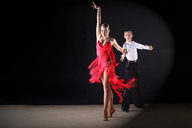 istock dancers in ballroom against black background 519622139
