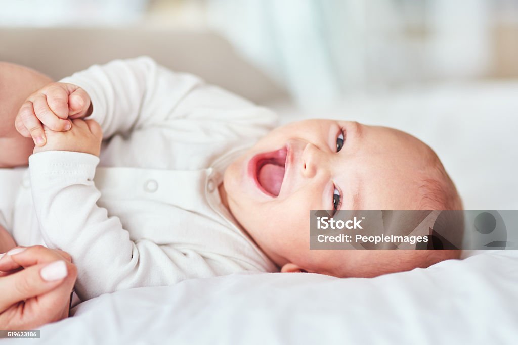 Giggles, cuddles and snuggles Shot of an adorable baby boy bonding with his mother at home Baby - Human Age Stock Photo