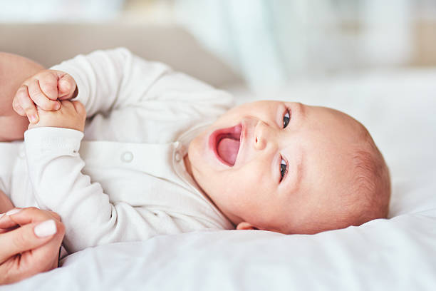 Giggles, cuddles and snuggles Shot of an adorable baby boy bonding with his mother at home baby boys stock pictures, royalty-free photos & images