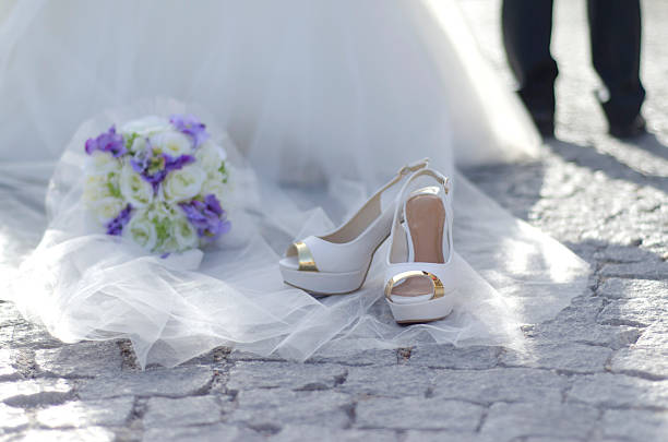 istock wedding bridal shoes with purple bouquet 519623628