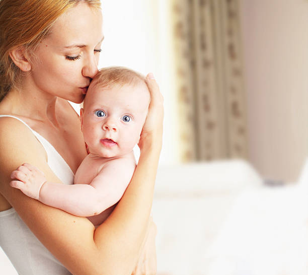 istock Mother with baby at home 519625261