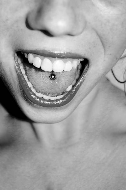 istock woman with tongue piercing 519625721