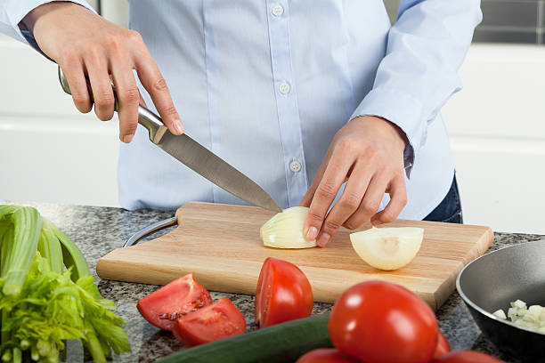 istock Woman cutting onion 519625935