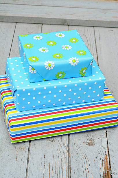 istock Three colored gifts on wood 519643723