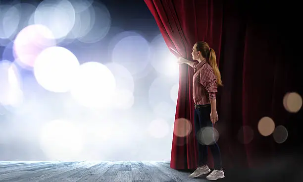 Photo of Girl opening curtain