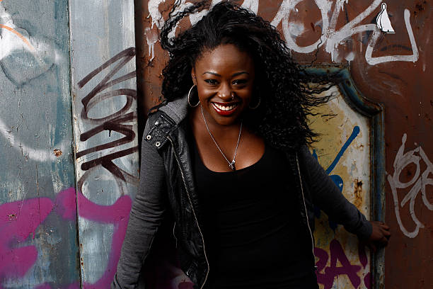 istock Close up Happy Black Woman Posing at Wall 519645361