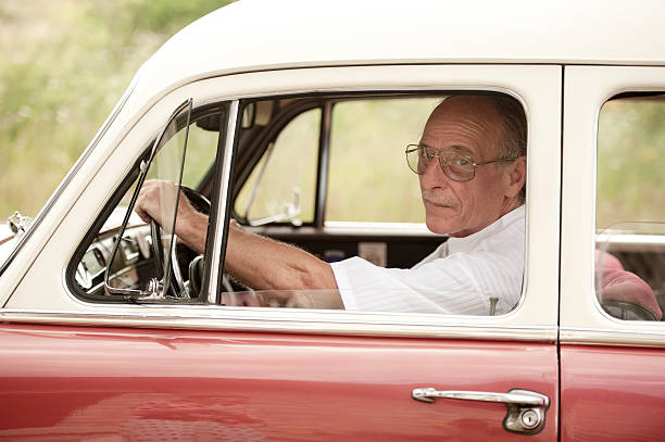 istock Senior Man Portrait in an Old Car 519645591