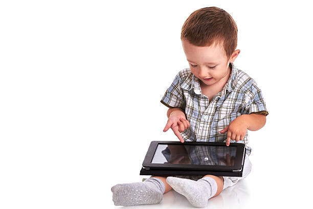 istock Baby toddler pointing confused at a digital tablet 519646619