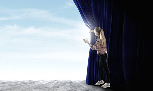 istock Girl opening curtain 519647927