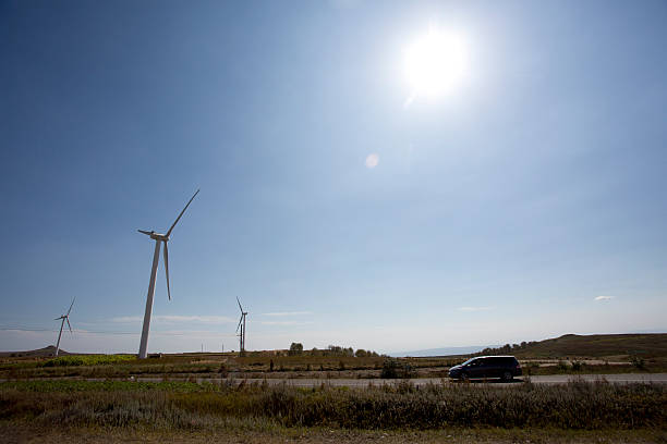 istock Wind mill far land along the road 519649475