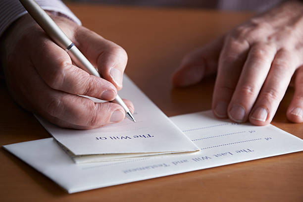 istock Close Up Of Man Completing Last Will And Testament 519650461